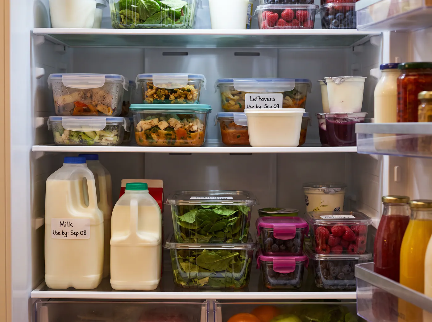Food containers and groceries marked with handwritten use-by labels